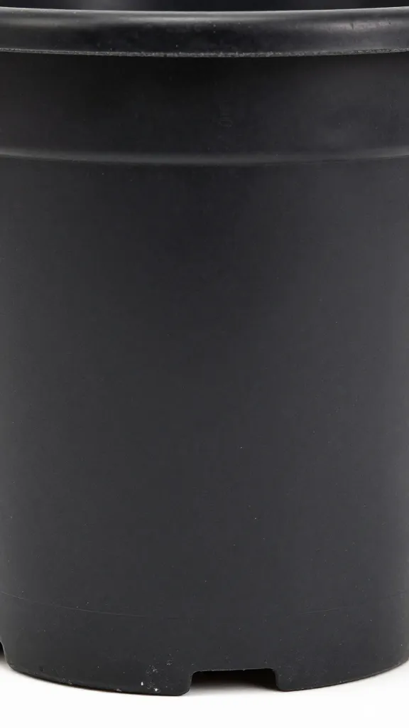 detail of drainage holes under black plastic planter